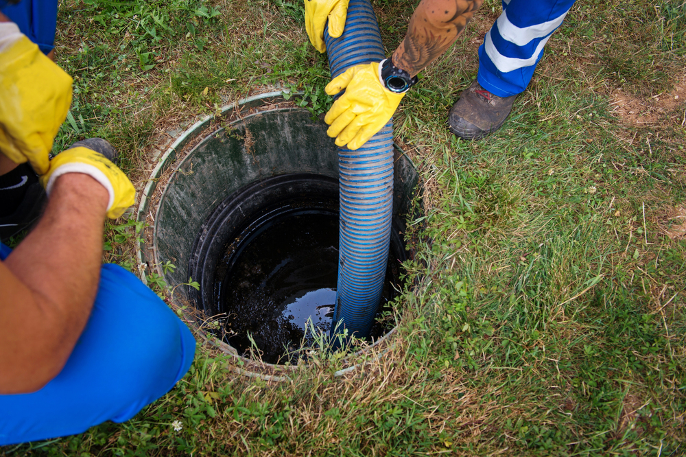Vacuum truck hose at a septic tank