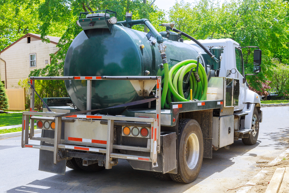 Septic service truck on a residential street