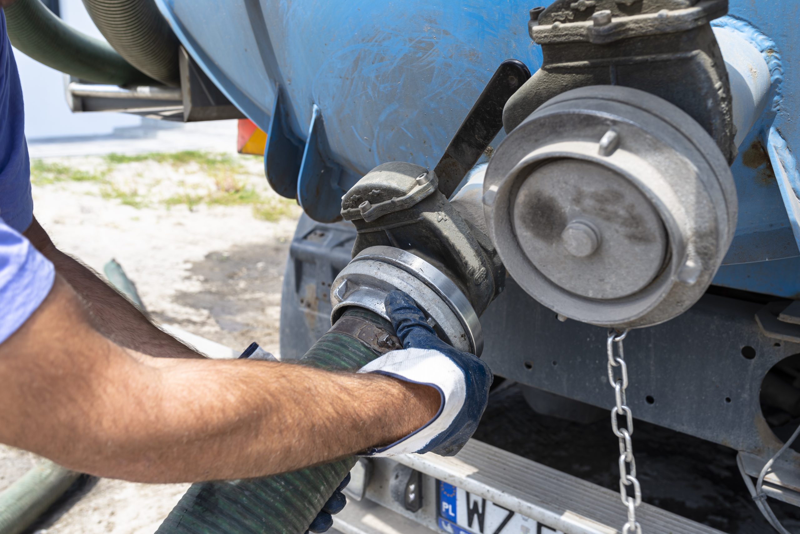 Connecting a hose to a large septic tanker truck